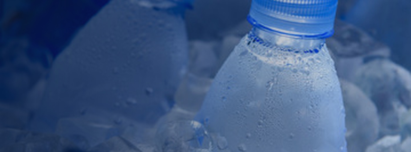Cold water bottles on ice with condensation